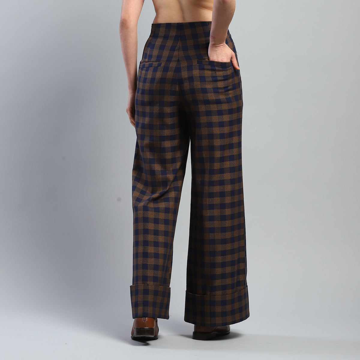 Plaid pants worn by a person on a gray background