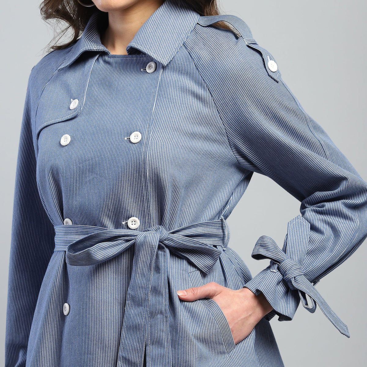 Blue striped dress with a belt on a gray background