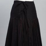 Black skirt with red stitching on a gray background