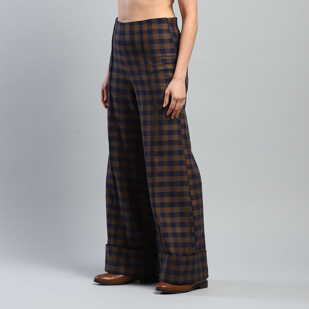 Plaid pants worn by a person on a gray background