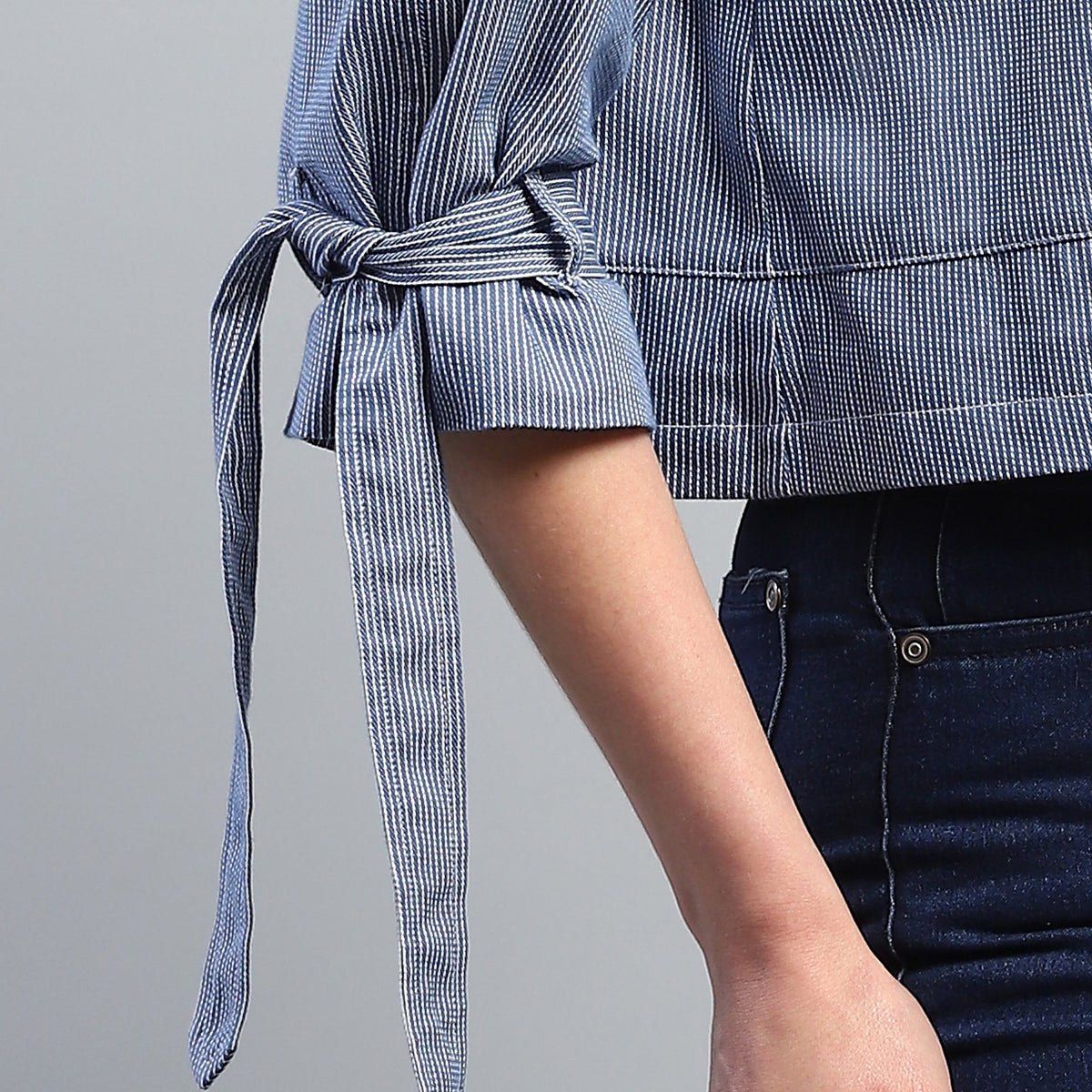 Blue checkered shirt with a tie waist on a gray background