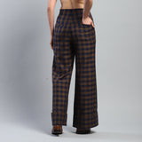 Plaid pants worn by a person on a gray background