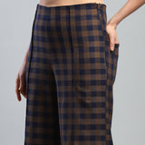 Plaid pants worn by a person on a gray background